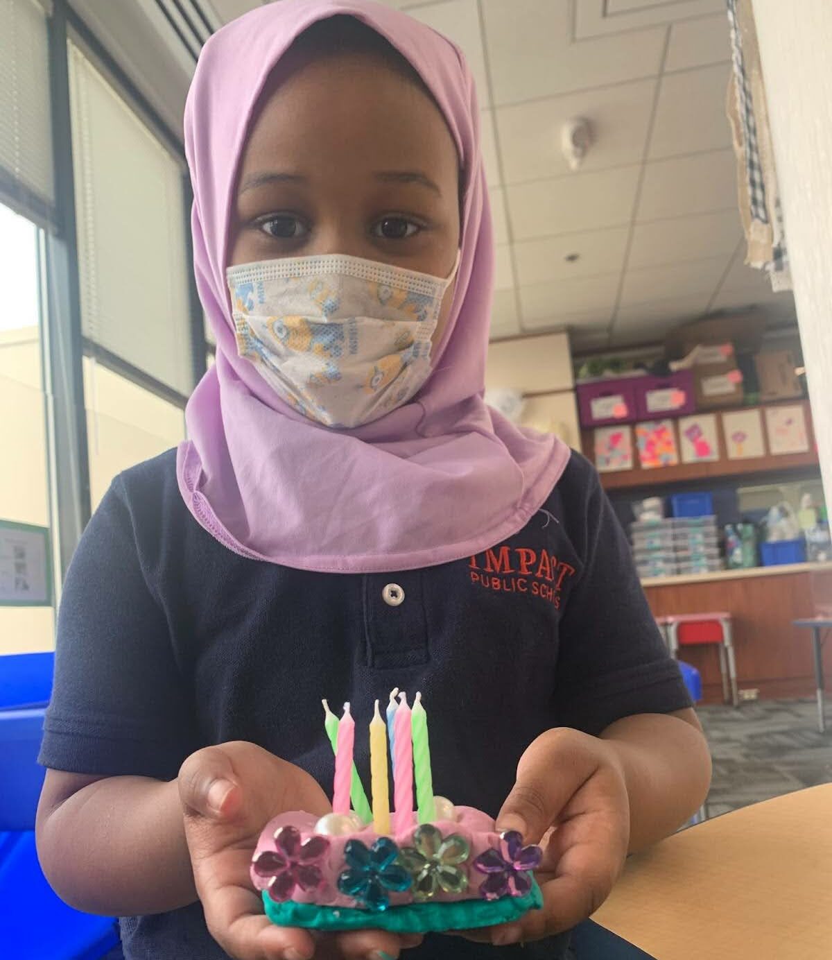 Scholars use props in their centers to support their play! This scholar was the Baker in the Bakery, completing a birthday cake order for a customer. She accurately counted six candles for her customer!